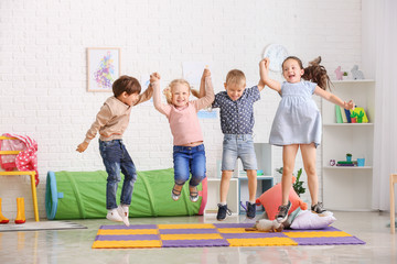 Jumping little children in kindergarten