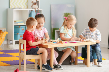 Cute little children playing in kindergarten