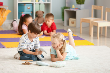 Cute little children playing in kindergarten