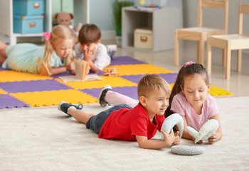 Cute little children playing in kindergarten