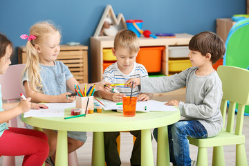 Cute little children drawing in kindergarten