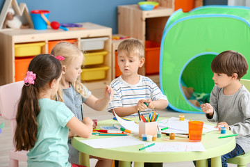 Cute little children drawing in kindergarten