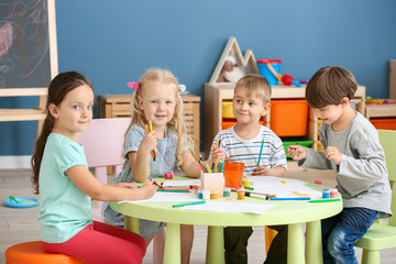 Cute little children drawing in kindergarten