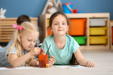 Cute little children painting in kindergarten
