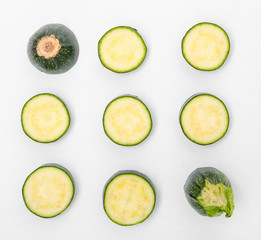 Composition with fresh cut zucchini on white background