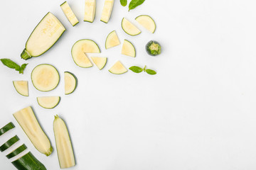 Composition with fresh cut zucchini on white background
