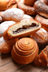 Heap of tasty pastries on wooden background