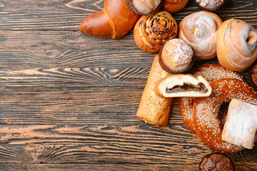 Heap of tasty pastries on wooden background