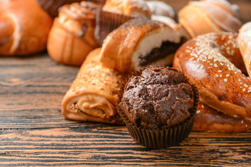 Heap of tasty pastries on wooden background
