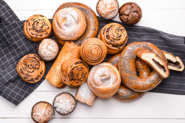 Heap of tasty pastries on white wooden background