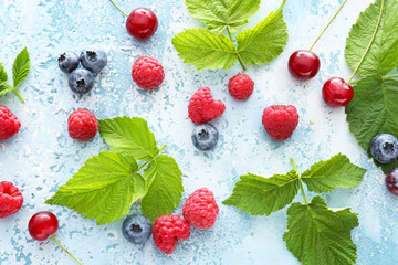 Sweet ripe berries on color background