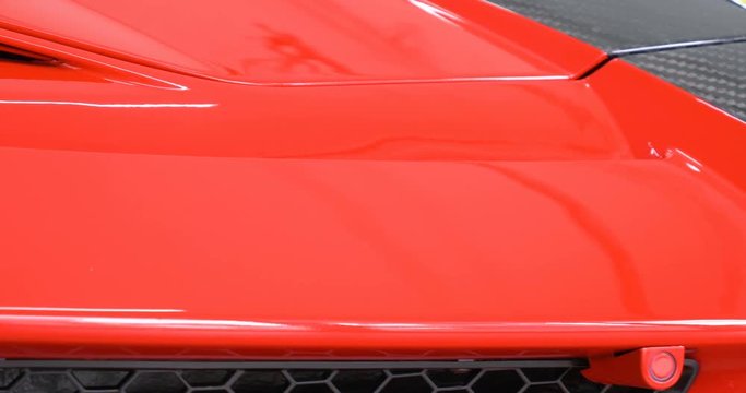 Very closely displayed different exterior of the car. New car after polishing and painting. Concept of: First Look, Sporty Car, Hood, Roof, Wheels, Chrome, Bumper, Spoiler, Slow Motion.
