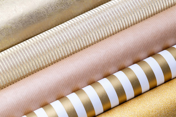 Golden glossy wrapping paper rolls