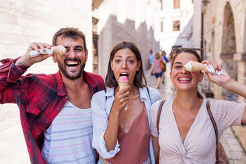 Friends eating ice cream and have fun on holiday