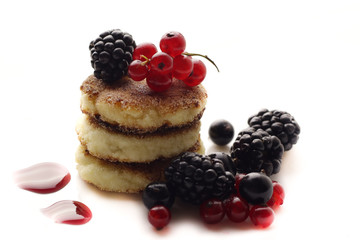Cottage cheese pancakes or syrniki on plate, close up