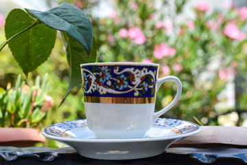 Turkish coffee, on green background. embroidered porcelain cup	