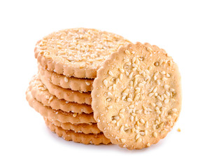 stack of cookies with grains of sugar and sesame seeds close-up isolated on white background