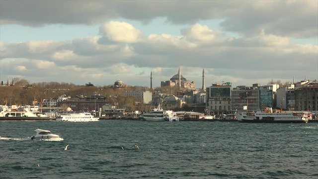 Beautiful view of the Hagia Sophia Cathedral in Istanbul. Hagia Sophia Cathedral view from the other side. Toristic boats float, seagulls fly. Turkish Cathedral. April 10, 2019