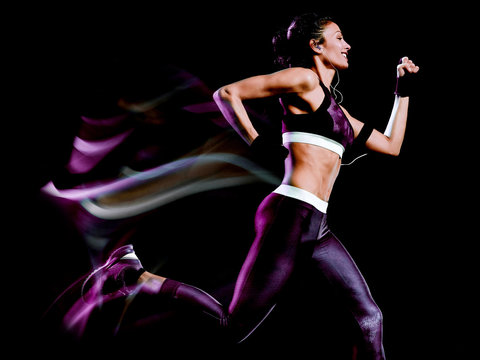 one beautiful caucasian mixed race woman unner jogger jogging running in studio isolated on black background