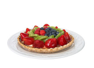 Fresh fruit tart on a pastry crust coated with chocolate on a white plate isolated on white background. Focus stacked for deeper depth of field.