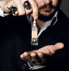 Male holding up bottle of perfume. Perfume or cologne bottle and perfumery, cosmetics