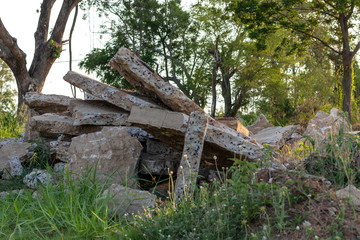 Fototapeta premium Concrete debris piles with sunlight in the countryside.