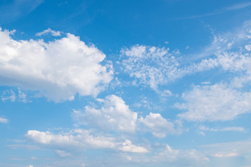 Naklejka na ściany i meble White clouds in the blue summer sky