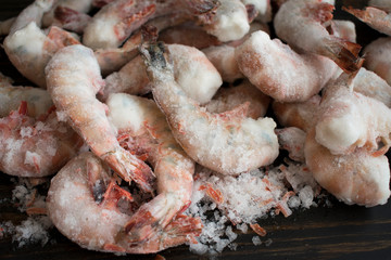 Frozen Jumbo Shrimp on a Wood Background