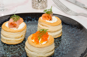 Puff pastry stuffed with cream cheese, smoked salmon and dill. Vol au vent starters. 