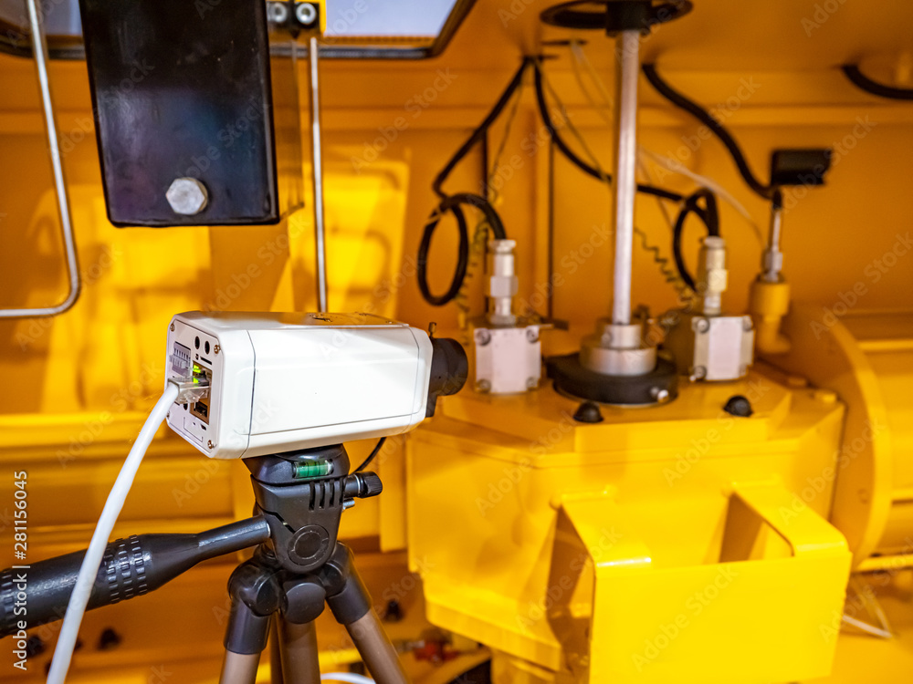 Poster video surveillance camera for production processes. operator of video surveillance. operational moni