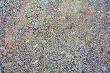 Dry mud ground, crack texture, granite gravel. Dry dirty soil. Cracks on clay