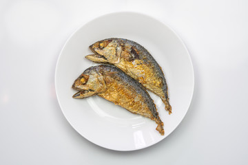 Steamed mackerel fish on the white plate.