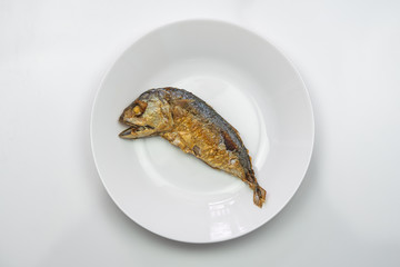 Steamed mackerel fish on the white plate.
