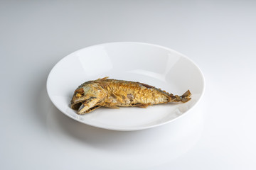 Steamed mackerel fish on the white plate.