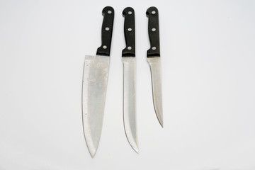 Various kitchen knives with black handle isolated with white background