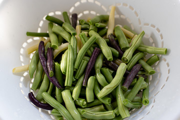 fresh green beans in the process of being cleand for cooking and canning.