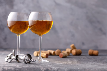 White wine in a glass. The concept of winemaking. Place under your text. Still life on a textural background.