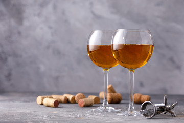 White wine in a glass. The concept of winemaking. Place under your text. Still life on a textural background.