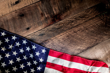 USA Flag draped across rustic background   