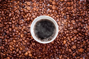 Styrofoam cup of hot coffee with coffee beans
