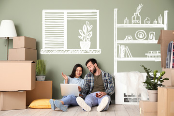Happy couple with laptop imagining interior of new house