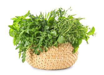 Wicker basket with different fresh herbs on white background