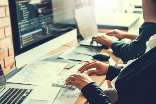 Developing programmer Team Development Website design and coding technologies working in software company office