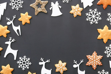 Frame made of Christmas decor and cookies on dark background