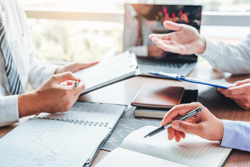 Business Team meeting Investment and Entrepreneur Trading Stock Market and Exchange discussing and analysis graph.
