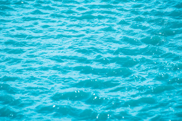 Abstract bokeh from light in the blue water wave