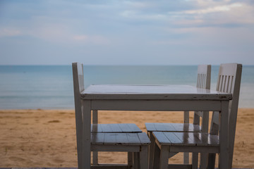 Fototapeta na wymiar White table for dinner on the beach and sky