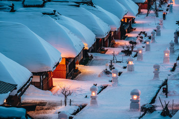 Light up illumination with thatched roof house,  village made of over 30 traditional Japanese houses  and snow covered street in Ouchi Juku village, Fukushima, Tohoku, Japan in Winter