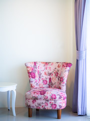 Beautiful pink vintage sofa on white wall background.