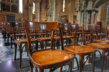 Fototapeta na wymiar Chairs for believers in the old Cathedral of Como